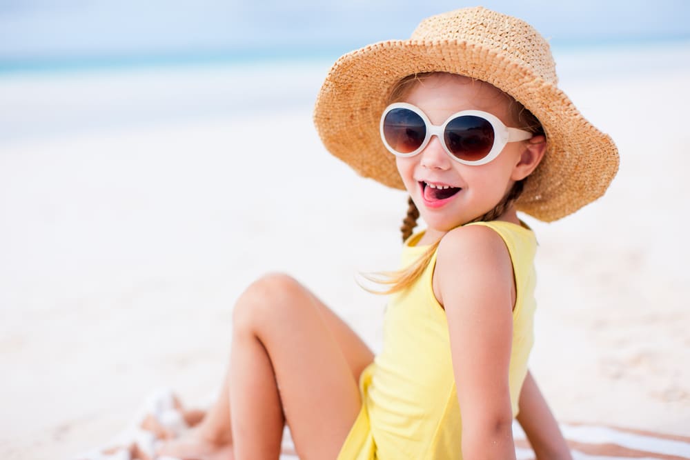 Adorable little girl at beach on summer vacation