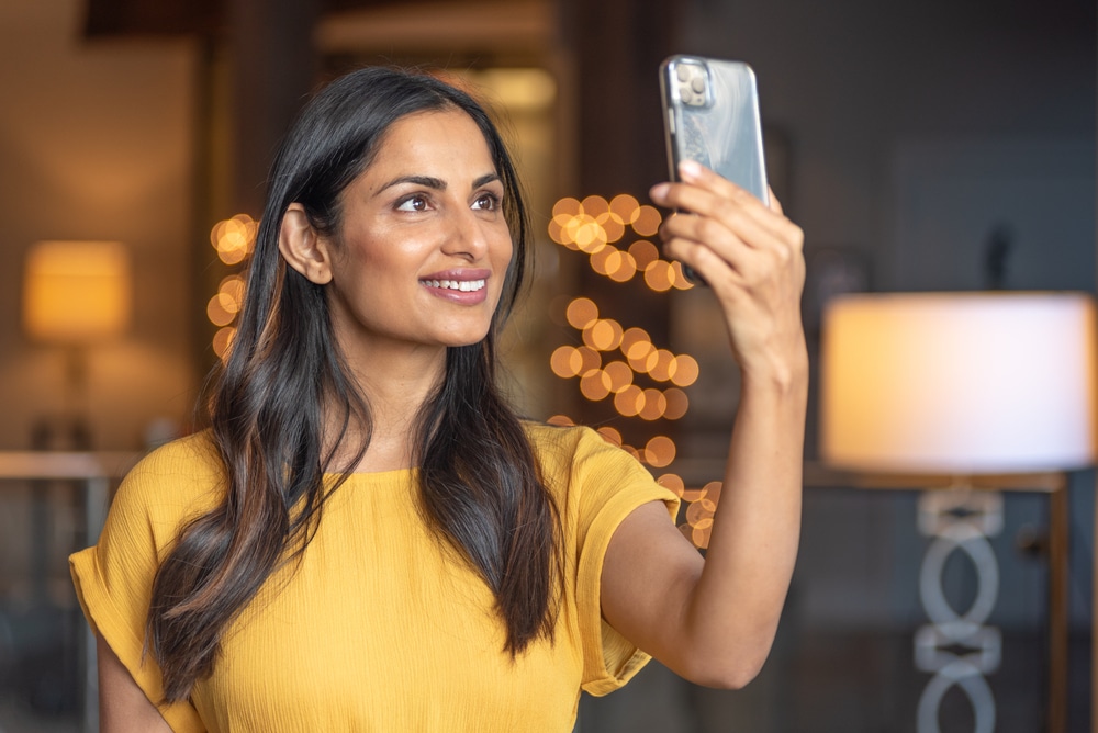 Beautiful Asian Indian woman taking a selfie.